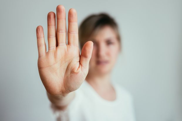 Frau mit Stop-Geste Eine Frau zeigt eine Stop-Geste mit einer Nahaufnahme auf die Handfläche